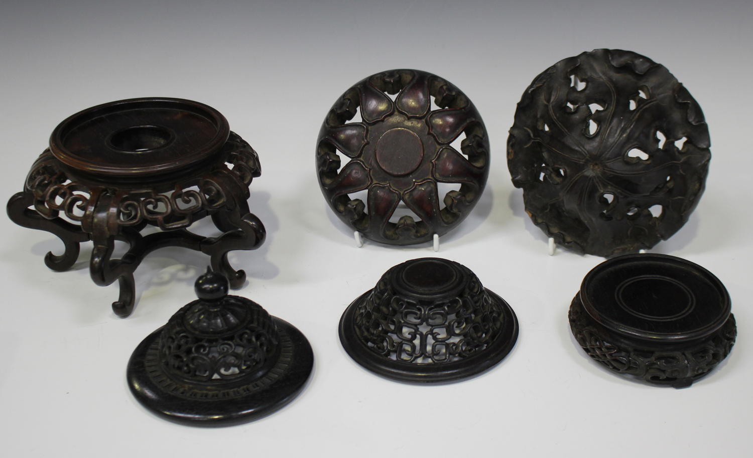 A Chinese hardwood domed cover/lid, late Qing dynasty, carved and pierced in the form of lotus