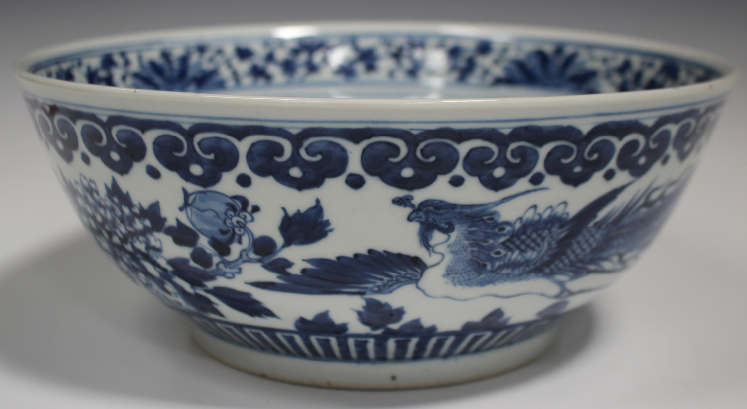 A Chinese blue and white porcelain punch bowl, late 19th century, the exterior painted with a pair - Image 6 of 6