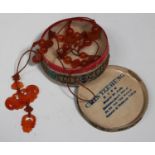 A Chinese carnelian pendant and bead necklace, 20th century, the pendant of carved and pierced