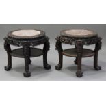 A near pair of Chinese hardwood two-tier stands, late Qing dynasty, each top inset with a rouge