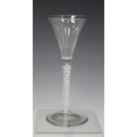 A double series opaque twist stem wine glass, mid-18th century, the flared trumpet bowl raised on