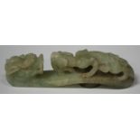 A Chinese jade belthook, 20th century, of typical serpentine form, carved and pierced with a chilong