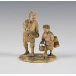 A Japanese ivory okimono figure group, Meiji period, modelled as a father and son feeding two birds,