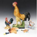 A Portuguese porcelain cockerel, 20th century, raised on a rectangular base, height 51.5cm, together