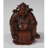 A Chinese carved boxwood figure of a god, 20th century, modelled standing wearing a long robe and