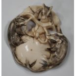 A Japanese ivory netsuke, Meiji/Taisho period, carved, pierced and stained with three rats upon a
