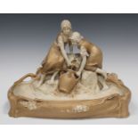 A Royal Dux porcelain centrepiece, early 20th century, modelled as two girls collecting water from a