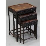 A Chinese hardwood nest of three occasional tables, early 20th century, each rectangular panelled