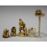 A Japanese carved and pierced ivory okimono figure group of a father and son, Meiji period, the