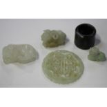 A small group of Chinese jade carvings, Qing dynasty and later, comprising a pale celadon jade