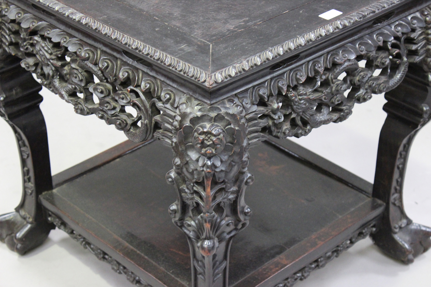 A Chinese carved hardwood stand, late 19th/early 20th century, the square panelled top with a carved - Image 2 of 7