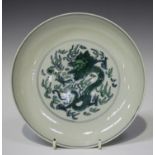 A Chinese doucai green enamelled porcelain saucer dish, mark of Kangxi but later, the centre painted