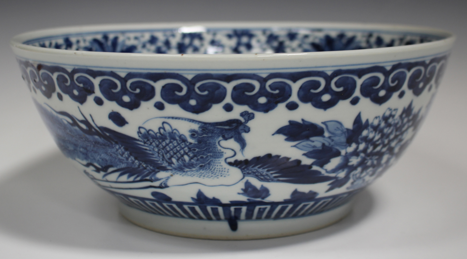 A Chinese blue and white porcelain punch bowl, late 19th century, the exterior painted with a pair