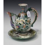 A Japanese Ko-Kutani ewer, Meiji period, the ovoid body painted with birds and flowers, flanked by a