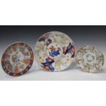 A Japanese Imari porcelain circular dish, Meiji period, painted with segmented panels of flowers and
