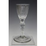 A faceted stem wine glass, late 18th century, the rounded funnel bowl with faceted base, raised on a