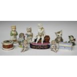 A French porcelain figure group, mid-19th century, modelled as a bisque putto teasing a dog with a