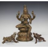 A group of three Indian bronze figures, 20th century, comprising Shiva, modelled with four arms,
