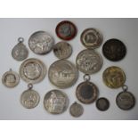 A group of sixteen mostly silver medallions and fob medallions relating to fisheries, dogs,