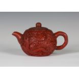 A rare Chinese cinnabar lacquered Yixing stoneware teapot and cover, late Qing dynasty, the