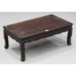 A Chinese hardwood low table, late 19th century, the rectangular panelled top above an archaistic