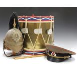 A 20th century copy of a military drum, together with a 20th century copy of a Guard's helmet and