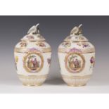 A pair of Berlin porcelain vases and covers, 19th century, each fluted ovoid body painted with