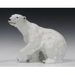 A Royal Dux porcelain polar bear, 20th century, modelled seated with one paw raised, applied pink