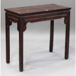 A Chinese hardwood centre table, late 19th century, the rectangular panelled top above a shaped