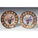 A pair of English porcelain Imari palette plates, probably Coalport, circa 1820, each with a central