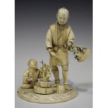 A Japanese carved sectional ivory okimono figure group of a father and son tending bonsai, Meiji