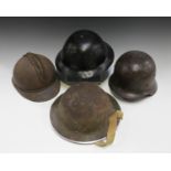 A group of four military helmets, comprising a Cromwell Protector helmet, a French M15 Adrian