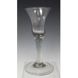 A plain stem wine glass, mid-18th century, the bell shaped bowl raised on a plain stem and folded