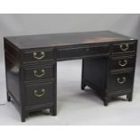 A Chinese black stained hardwood twin-pedestal desk, 20th century, the rectangular panelled top