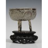 A Chinese silver bowl, late 19th/early 20th century, the circular body decorated in relief with