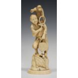 A Japanese marine ivory okimono carving, Meiji period, carved and pierced in the form of a monkey