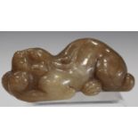 A Chinese brown jade carving, probably late 20th century, modelled as a recumbent crouching feline