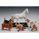 A group of mostly Beswick models of animals, including Spirit of the Wind, No. 2688, on a wooden