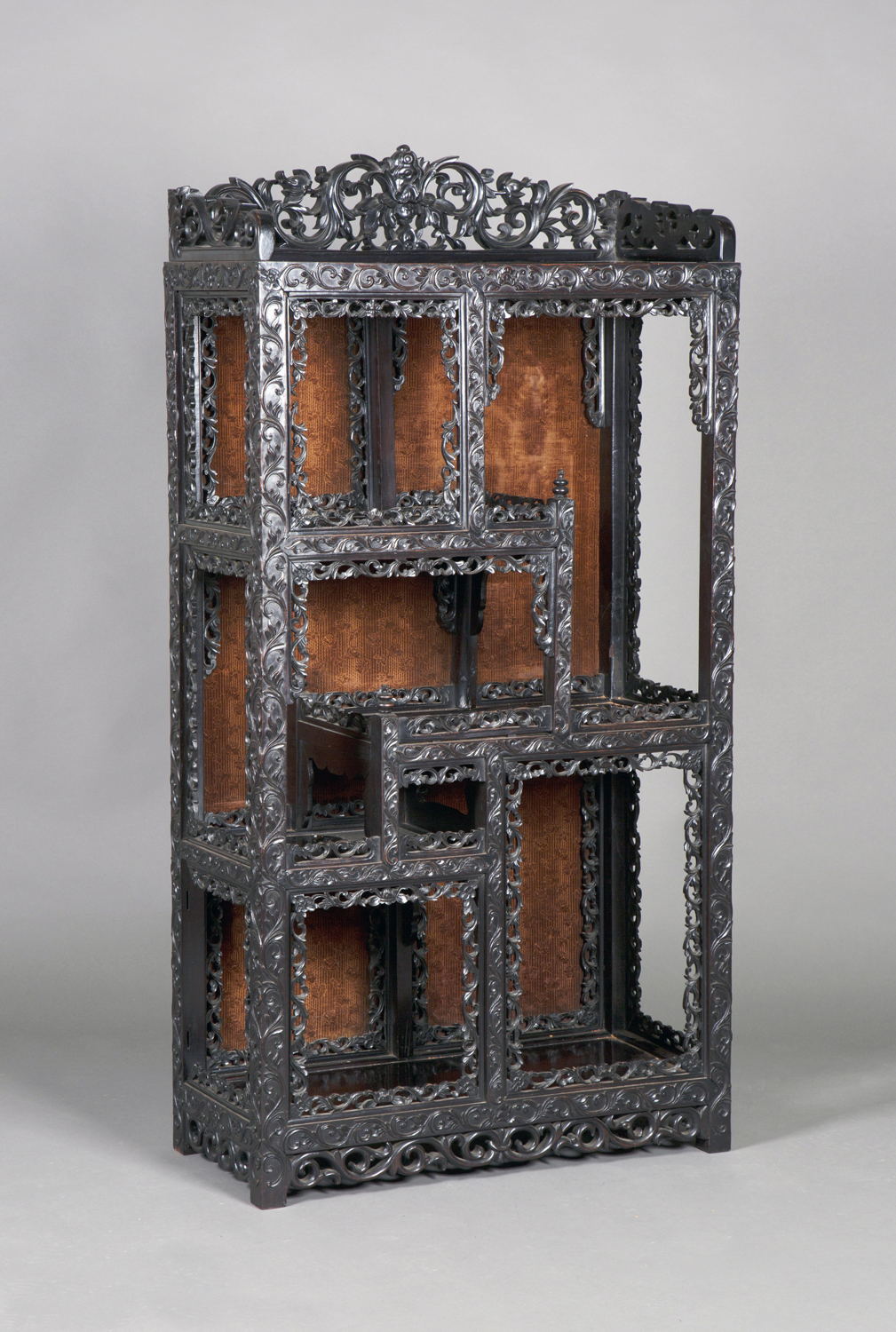 A Chinese carved hardwood display cabinet, late 19th/early 20th century, the rectangular panelled