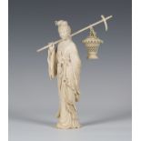 A Chinese carved ivory figure of a lady, late Qing dynasty, the standing maiden finely modelled