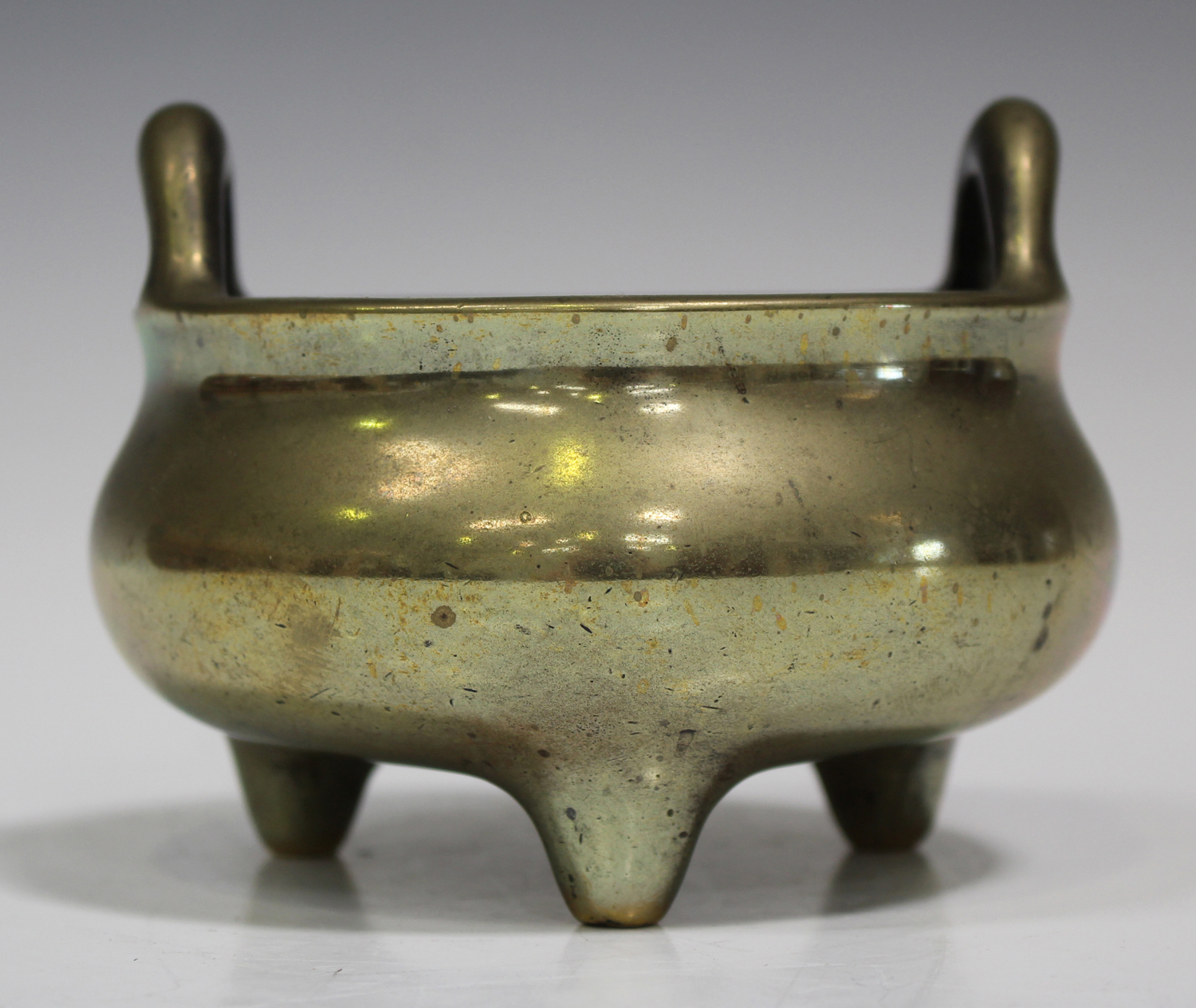 A Chinese polished bronze bombé censer, mark of Xuande but late Qing dynasty, of low-bellied