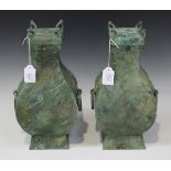 A pair of Chinese bronze wine jars and covers (fang hu), Han dynasty (206 BC- 220 AD), each of