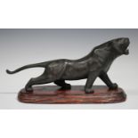 A Japanese brown patinated bronze model of a tiger, Meiji/Taisho period, modelled standing with