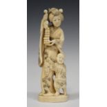 A Japanese marine ivory okimono carving, Meiji period, carved and pierced in the form of a mother