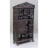 A Chinese hardwood cabinet, late 19th/early 20th century, the three-quarter gallery carved and