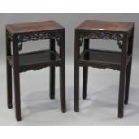 A pair of Chinese hardwood two-tier stands, late 19th century, each rectangular panelled top above a