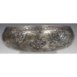 A Persian tinned-copper circular bowl, probably 19th century, the exterior engraved with foliate