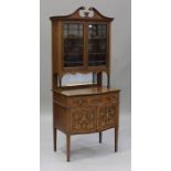 An Edwardian mahogany and foliate inlaid display cabinet, the swan neck pediment above a pair of