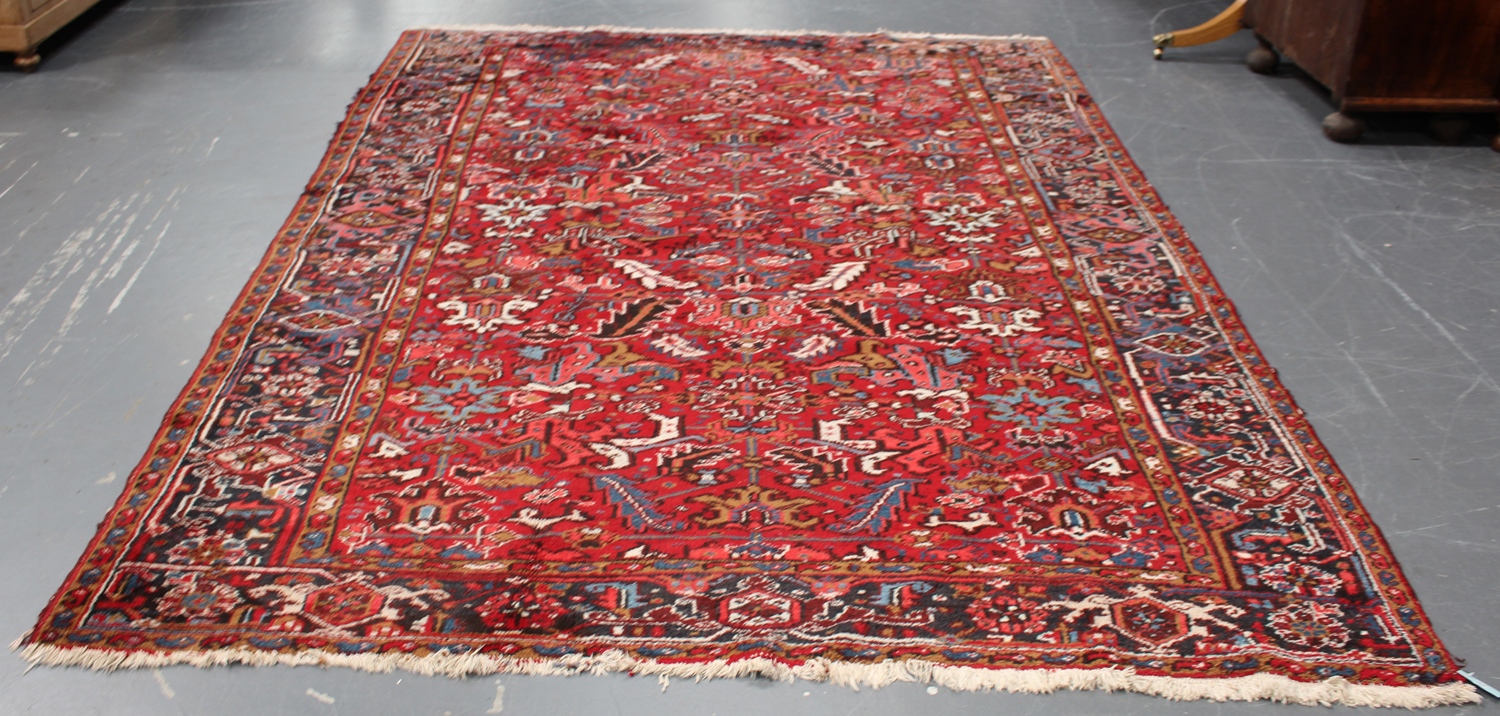 A Heriz carpet, North-west Persia, mid-20th century, the red field with overall palmettes and