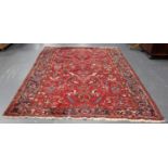 A Heriz carpet, North-west Persia, mid-20th century, the red field with overall palmettes and